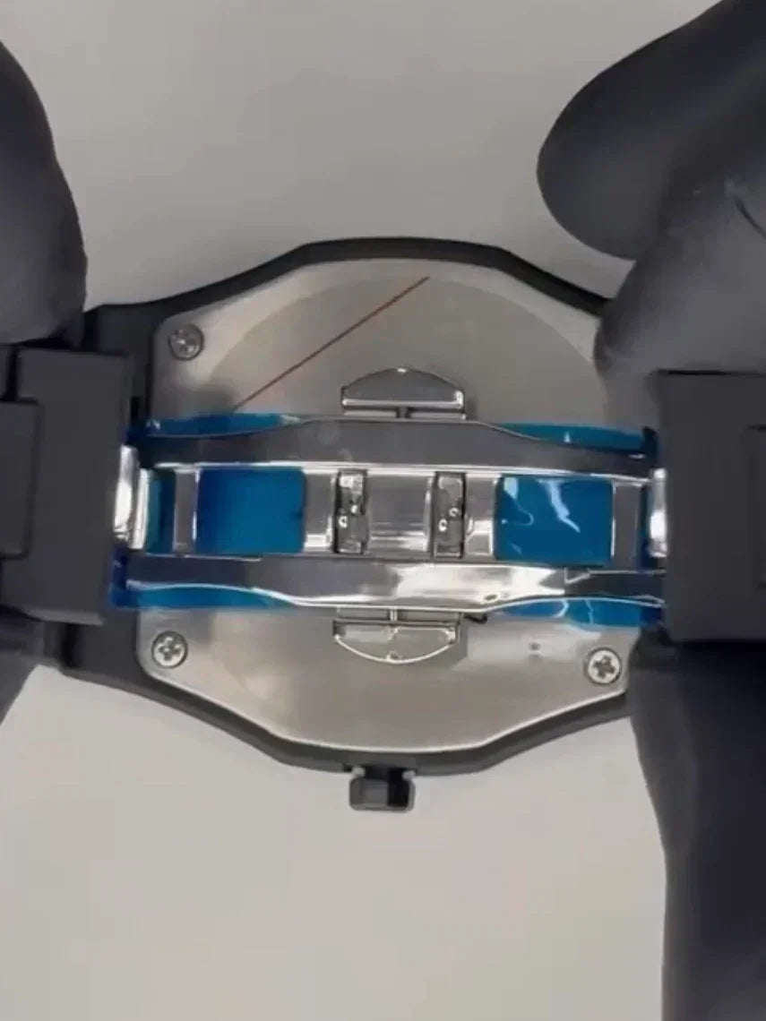 Close-up of Aura Black watch clasp with protective film and gloved hands