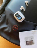 white wireless earbuds with digital display and charging case on black Dell laptop bag and wooden table